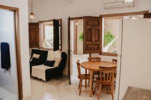 a living room with a table and a couch at Flats Beija-Flor in Itacaré
