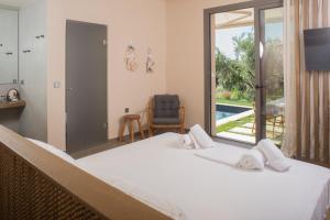 a bedroom with a large bed with towels on it at Elaia Grove in Kalamata