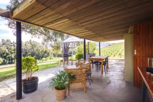 an outdoor patio with a table and chairs at Arendsig Wine Estate & Cottages in Bonnievale