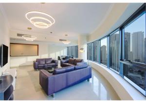 a living room with couches and a large window at Spacious 3 BR Suite with Marina View - Near Marina Mall in Dubai