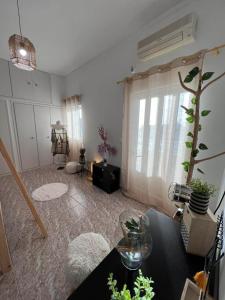 a living room with a table and a window at Beach apartment Edem first floor in Perivolos