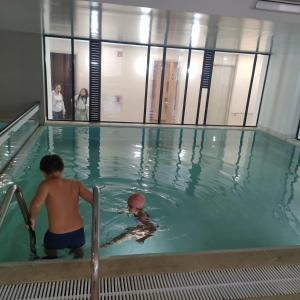 two children playing in a swimming pool at Apartamento en zona norte bogota in Bogotá