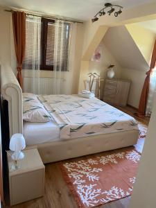 a bedroom with a large bed in a attic at Casa din Deal in Sibiu +148 photos