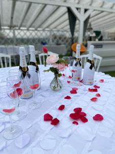 a table with wine bottles and red roses on it at Casa din Deal in Sibiu +148 photos