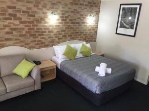 um quarto com uma cama com uma cruz em Country Gardens Motor Inn em Toowoomba