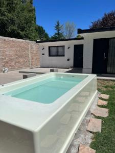 a swimming pool in the yard of a house at Andrea Houses in Chacras de Coria