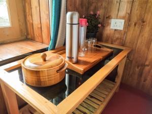 a wooden room with a thermos on a table at Sakti Homestay in Chimre