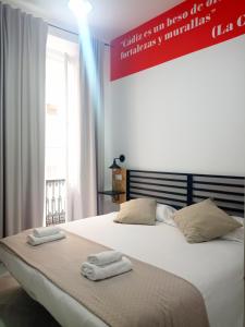Posteľ alebo postele v izbe v ubytovaní Planeta Cadiz Hostel