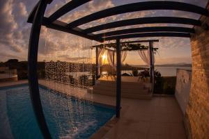 an outdoor pool with a gazebo and a wedding at Casa Florida do Lago in Guapé +31 photos