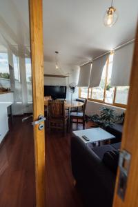 a living room with a couch and a table at Hospes - Departamento in San Rafael