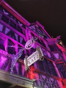 un edificio viola con un cartello stradale sopra di Appartement Le Saver'Zaru, centre ville, T2 55m² a Saverne