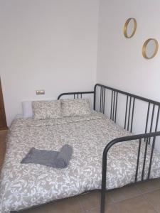 a gray hat laying on a bed in a bedroom at Casa Sol y Luna in Costa Calma +8 photos