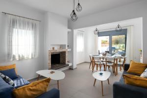 a living room with a blue couch and a fireplace at Dama Dama Villas in Gennadi