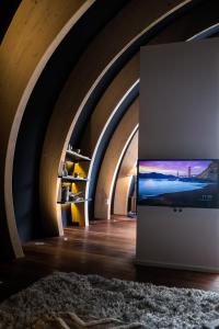 a room with a tv on a wall in a tunnel at Luxury Glamping Room8 a private hideaway from Brussels in Huldenberg