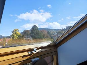 een raam met uitzicht op de bergen bij Appt centre Gerardmer in Gérardmer