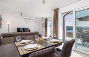 a dining room with a table and chairs and a large window at Villa Milla in Opatija