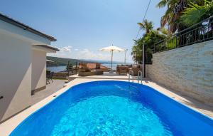 a large blue swimming pool in a house at Villa Milla in Opatija