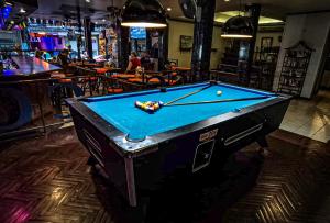 a pool table in a bar with a pool ball at Little Mermaid Guesthouse & Restaurant in Kata Beach