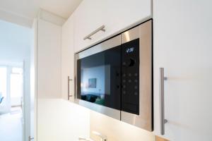 TV a/nebo společenská místnost v ubytování Ferienwohnung Meerblick App 805