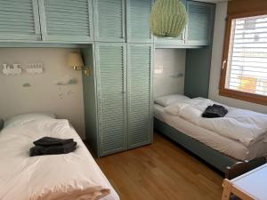 a bedroom with two beds with towels on them at Spacious apartment up to 6 people in Flims in Flims