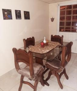 a dining room table and chairs with a glass table at Araucarias Inn in Santa Rosa de Cabal