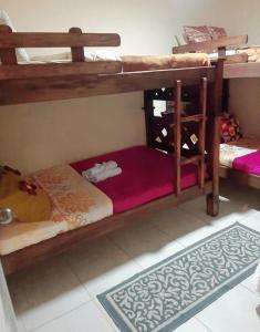 a bedroom with two bunk beds and a rug at Araucarias Inn in Santa Rosa de Cabal