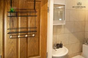 a bathroom with a toilet and a sink at 2 bed Apartment by UK Corporate Relocations Ltd in Warrington