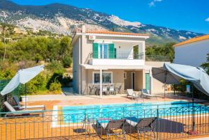 a villa with a swimming pool and a house at Villa Erasmia in Vlachata