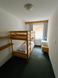 a bedroom with two bunk beds and a window at Haus Edelweiss in Fendels