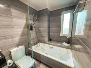 a bathroom with a toilet and a bath tub at The Marbella Heights Boutique Hotel in Marbella