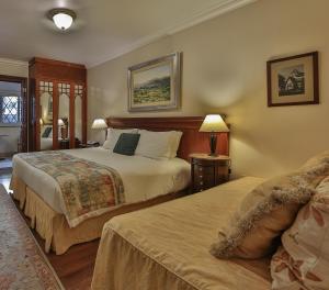 a hotel room with two beds in a room at Le Suisse Elegance Hotel in Campos do Jordão +54 photos