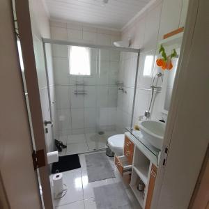 La petite salle de bains est pourvue d'un lavabo et de toilettes. dans l'établissement Casa Vista do Vale próxima ao Vale dos Vinhedos, à Bento Gonçalves