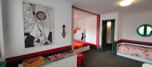 a bedroom with a bed and a mirror and a room with a bed sidx sidx at Hostdomus - Modern Art Flat in Sestriere