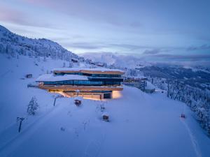 a building on top of a snow covered mountain at Ferienwohnungen Luxner in Fügen
