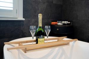 a bottle of wine and two wine glasses on a tray at The Petersham in Richmond upon Thames