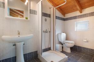 a bathroom with a toilet and a sink and a shower at Dolphin Apartment Sea View 12 in Keri