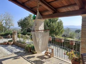 a hammock on a patio with a fence at VILLETTA TRA GLI ULIVI in Citta' Sant'Angelo