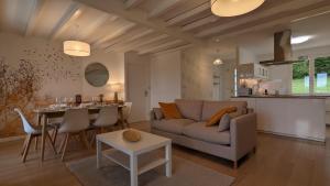 a living room with a couch and a table at L'Orée du bois in Selongey