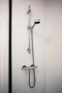 a shower with a shower head in a bathroom at Pine Street Home by #ShortStaysAway in Willington Quay