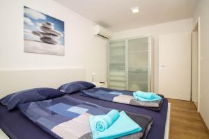 a bedroom with a large bed with towels on it at Luxury Apartment Luna in Vantačići