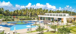 an image of a resort with a pool and palm trees at Muro Alto Condomínio Clube in Porto De Galinhas
