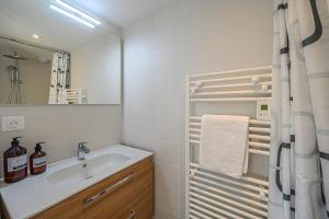 a bathroom with a sink and a mirror at Ty-Voli - Magnifique Longère rénovée in Plougoumelen +23 photos