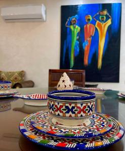 een tafel met kleurrijke kommen en borden op een tafel bij Stay In Fez in Fès