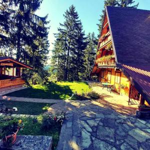 a large house with a yard next to a building at Holiday Home Tirol in Vlasic