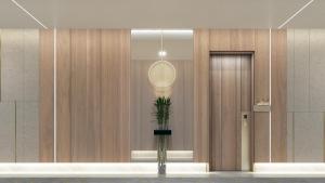 a lobby with a mirror and a plant in a vase at Holiday Inn & Suites - Al Khobar, an IHG Hotel in Al Khobar