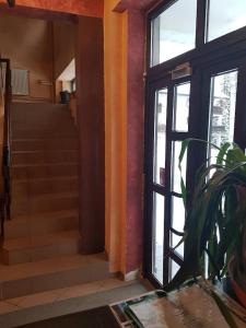 an entrance to a house with a door and stairs at Vila Predeal Holidays in Predeal