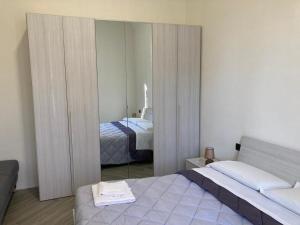 a bedroom with a mirror and a bed in it at Pigneto Square Home in Rome