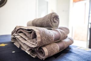 a pile of towels sitting on top of a table at Inn Tzfat in Safed