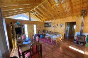 a large living room with a table and chairs at Casona los boldos in Santa Cruz