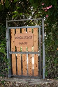 a gate with a sign that reads angelfars house at angelikashouse,big house in Corfu Town